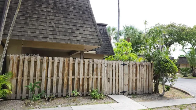 a view of a street with wooden fence