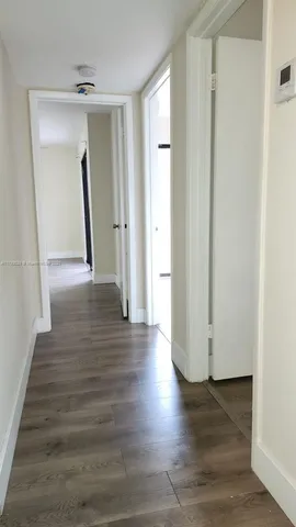 a view of a hallway view with wooden floor and staircase