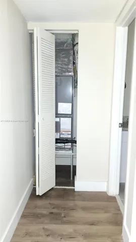 a view of a kitchen from a hallway