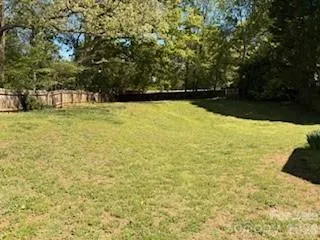 a view of yard with swimming pool and trees