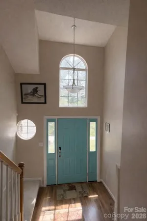an empty room with window wooden closet and windows