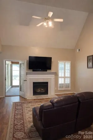 a living room with furniture a fireplace and a flat screen tv