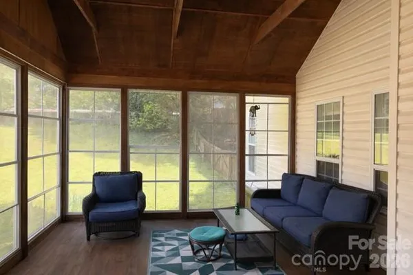 a living room with furniture and a floor to ceiling window