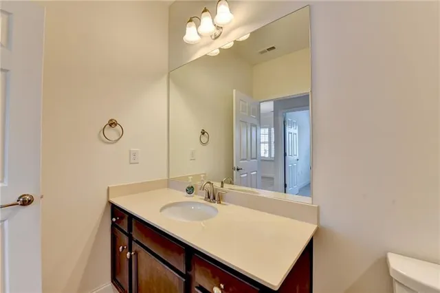 a spacious bathroom with a double vanity sink a large mirror and a shower