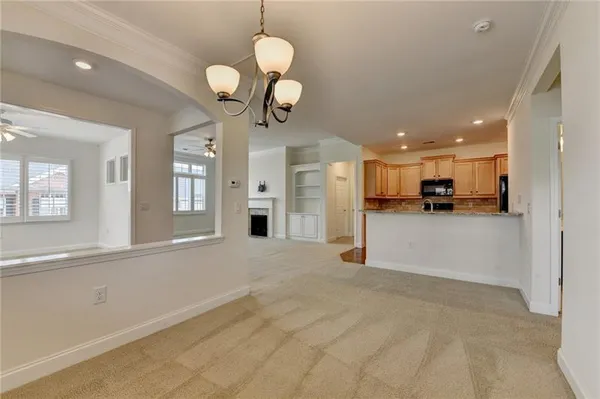 a view of an empty room with a fireplace and a window