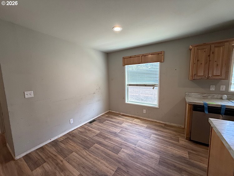 16125 Hawks Lair Road La Pine, OR 97739 - Photo 9 of 35 an empty room with wooden floor and windows