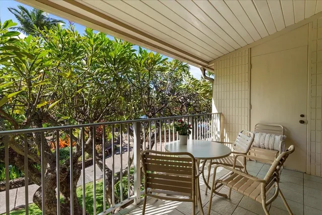 a view of a chairs and table in the balcony