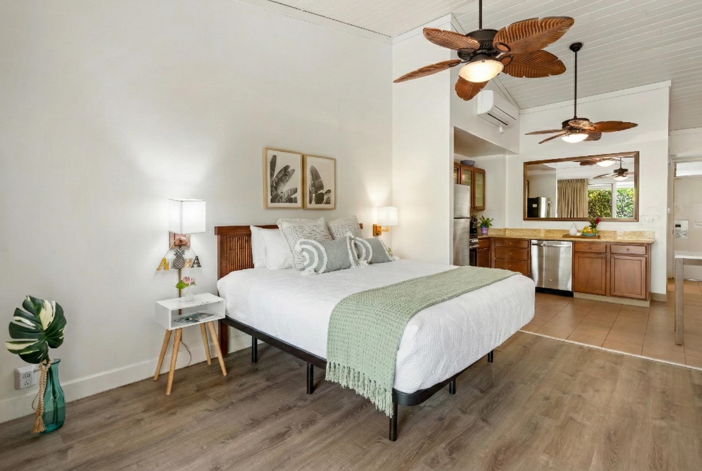 5315 Lower Honoapiilani Road, Unit D232 Lahaina, HI 96761 - Photo 21 of 31 a spacious bedroom with a bed and a chandelier