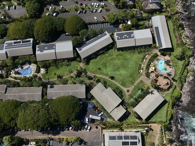 an aerial view of a house with garden space and street view