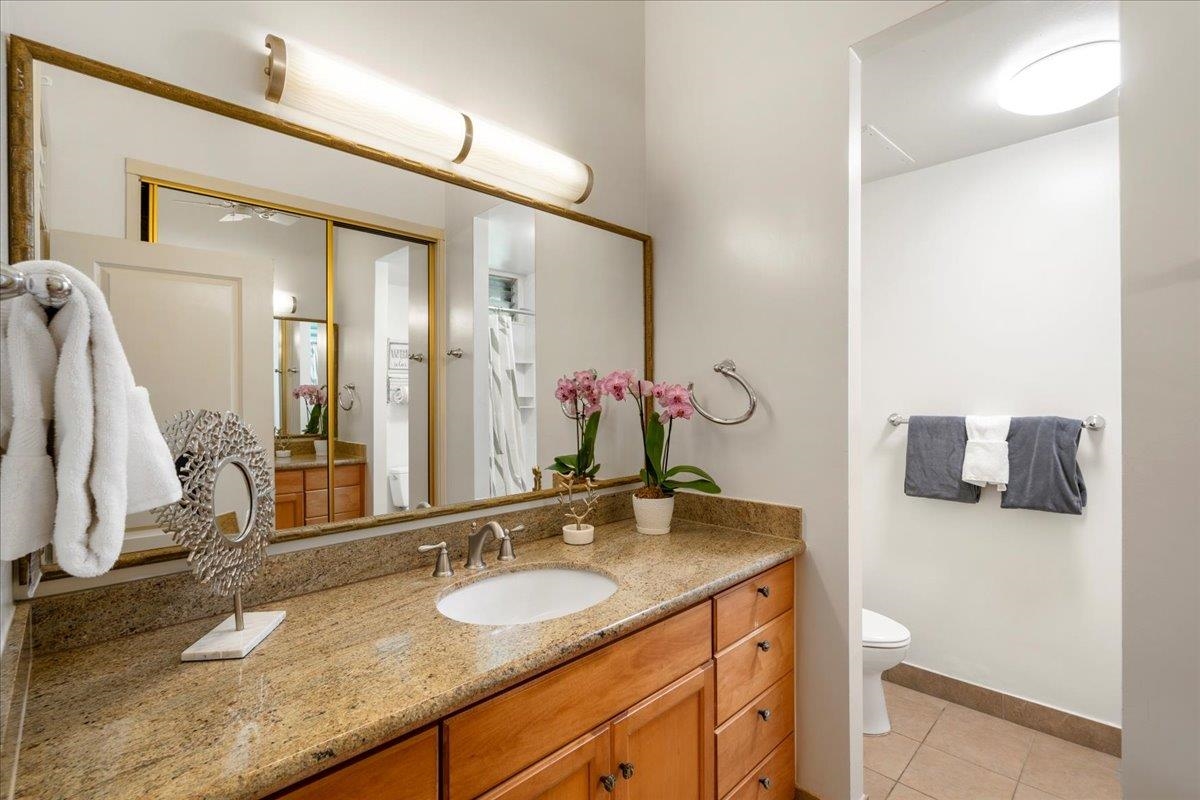 5315 Lower Honoapiilani Road, Unit D232 Lahaina, HI 96761 - Photo 9 of 31 a bathroom with a granite countertop sink and a mirror