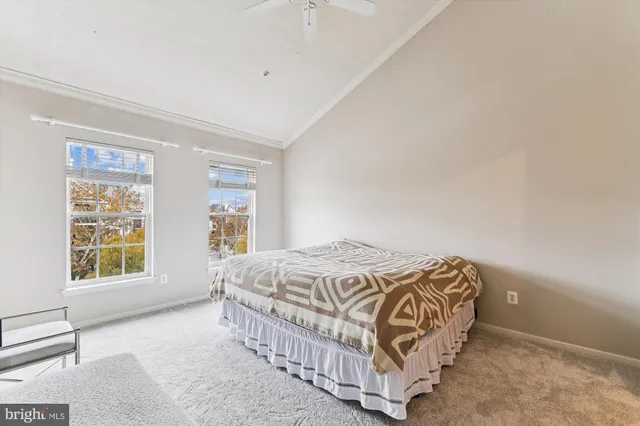 a bedroom with a bed lamp and a window