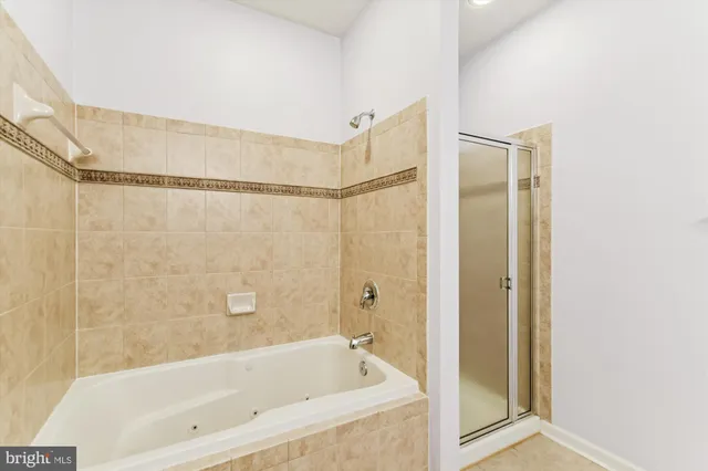 a bathroom with a bathtub and a shower