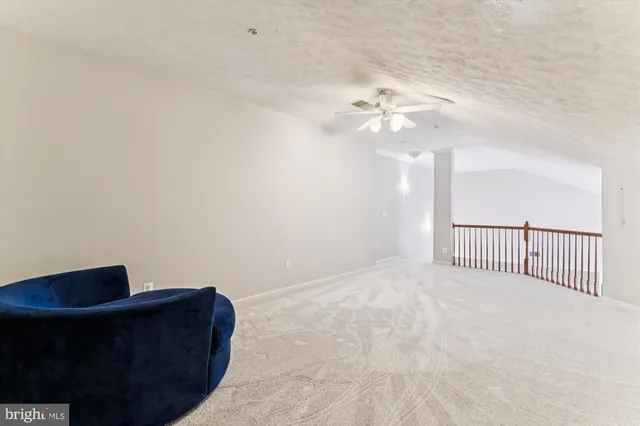 a view of a livingroom with a ceiling fan and a rug