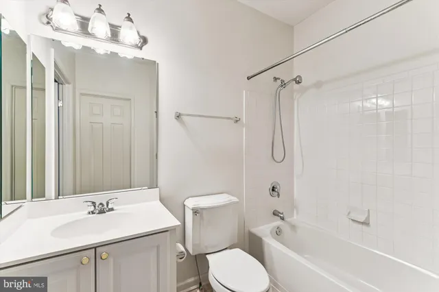 a bathroom with a sink toilet vanity and shower