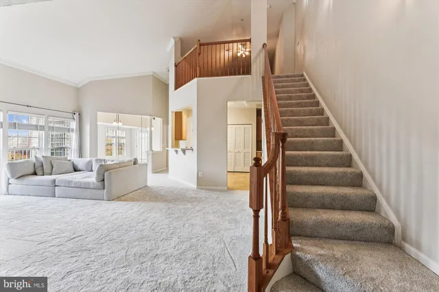 a view of a livingroom with furniture and stairs