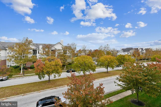 a sign board with a play ground in the back