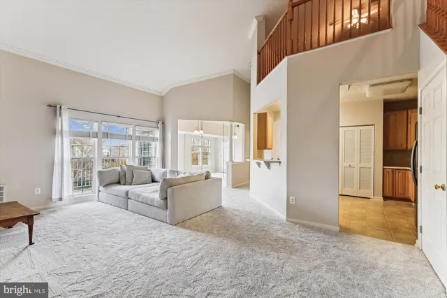 a living room with furniture and large windows