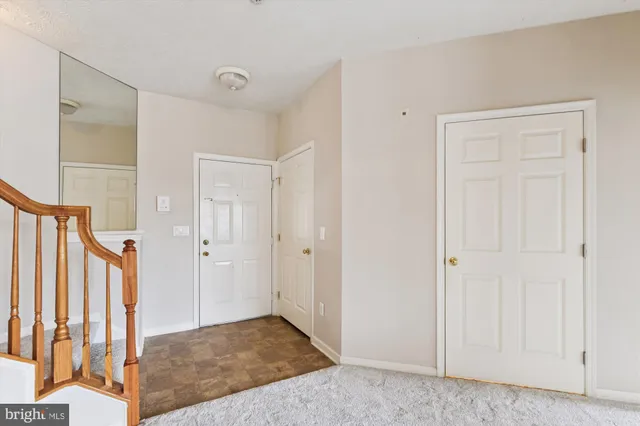 a view of a hallway with a large window and entryway