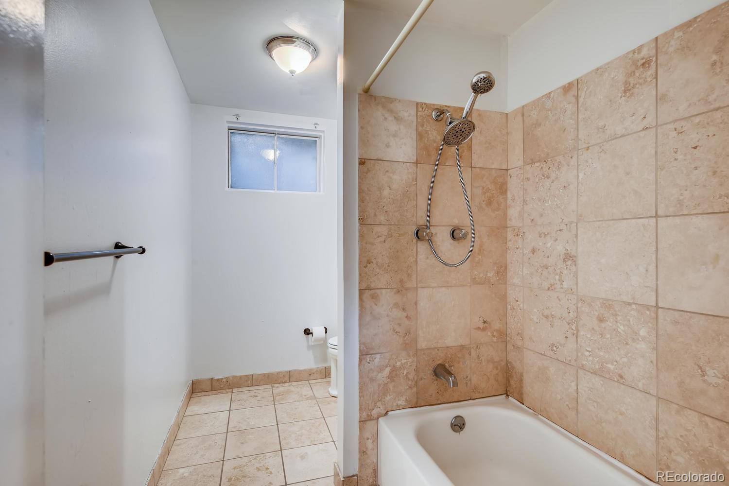 6644 South Race Circle East Centennial, CO 80121 - Photo 13 of 20 a bathroom with a tub shower and vanity