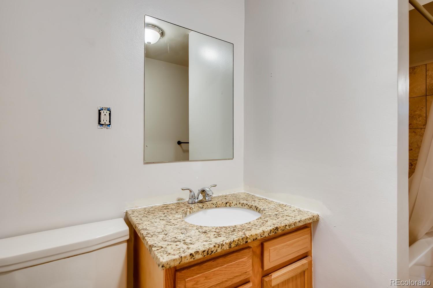 6644 South Race Circle East Centennial, CO 80121 - Photo 14 of 20 a bathroom with a granite countertop sink and a mirror