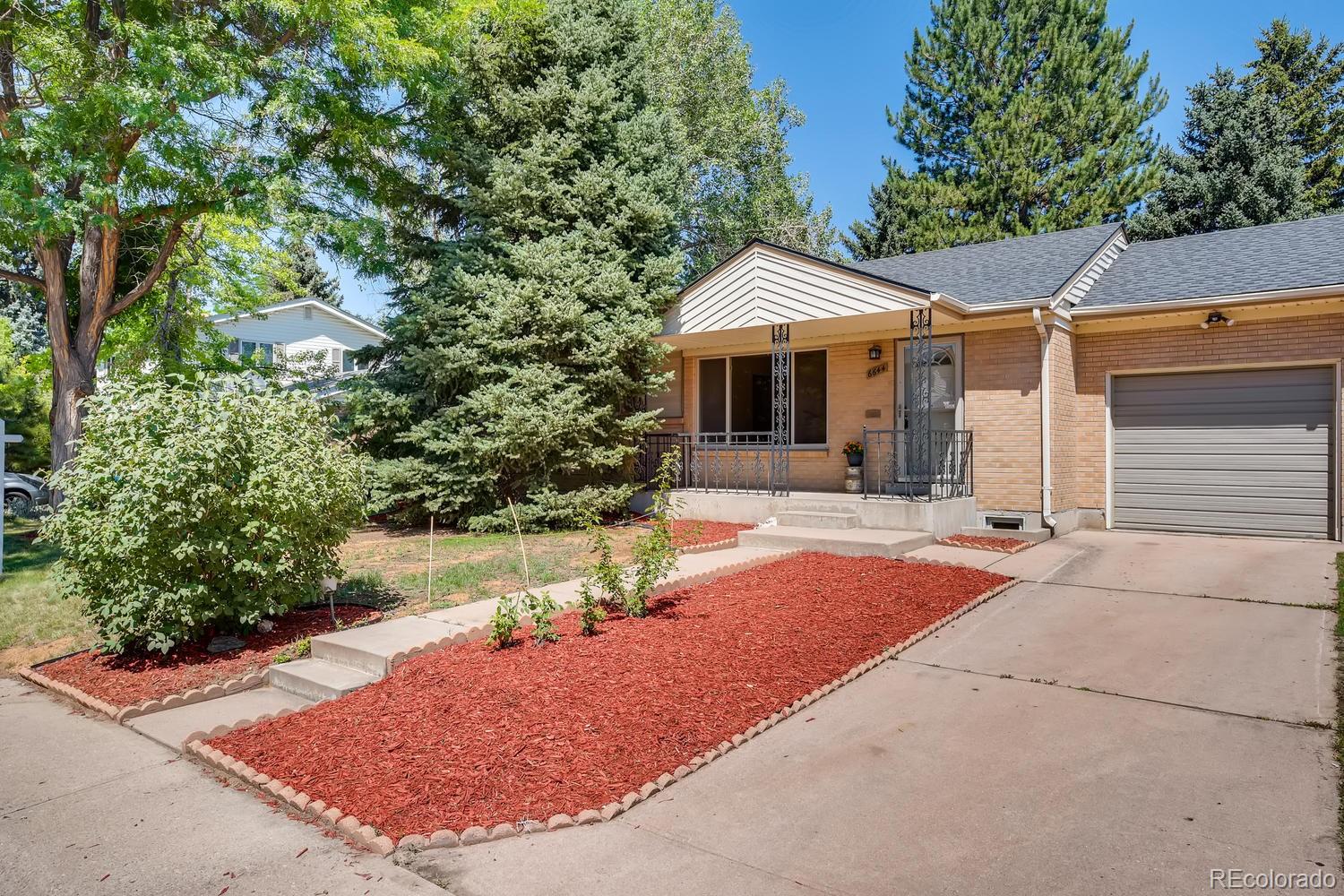 6644 South Race Circle East Centennial, CO 80121 - Photo 20 of 20 a view of a white house with a yard plants and large tree