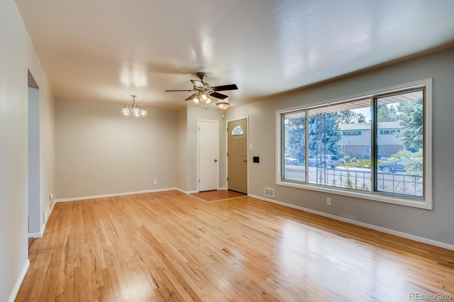 6644 South Race Circle East Centennial, CO 80121 - Photo 2 of 20 a view of an empty room with a window and wooden floor
