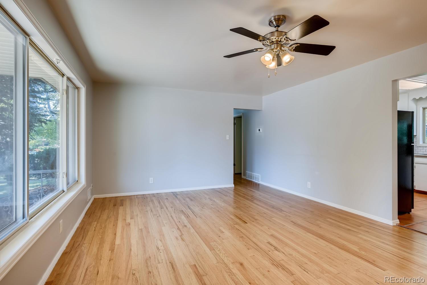 6644 South Race Circle East Centennial, CO 80121 - Photo 3 of 20 a view of an empty room with wooden floor and a window