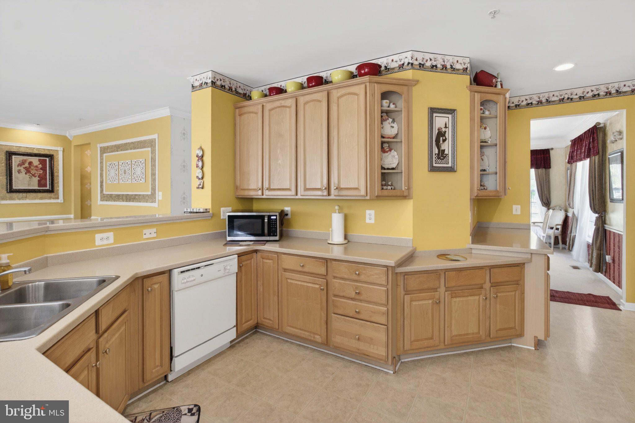 14305 Lightfoot Street Accokeek, MD 20607 - Photo 27 of 66 a kitchen with stainless steel appliances granite countertop a sink and cabinets