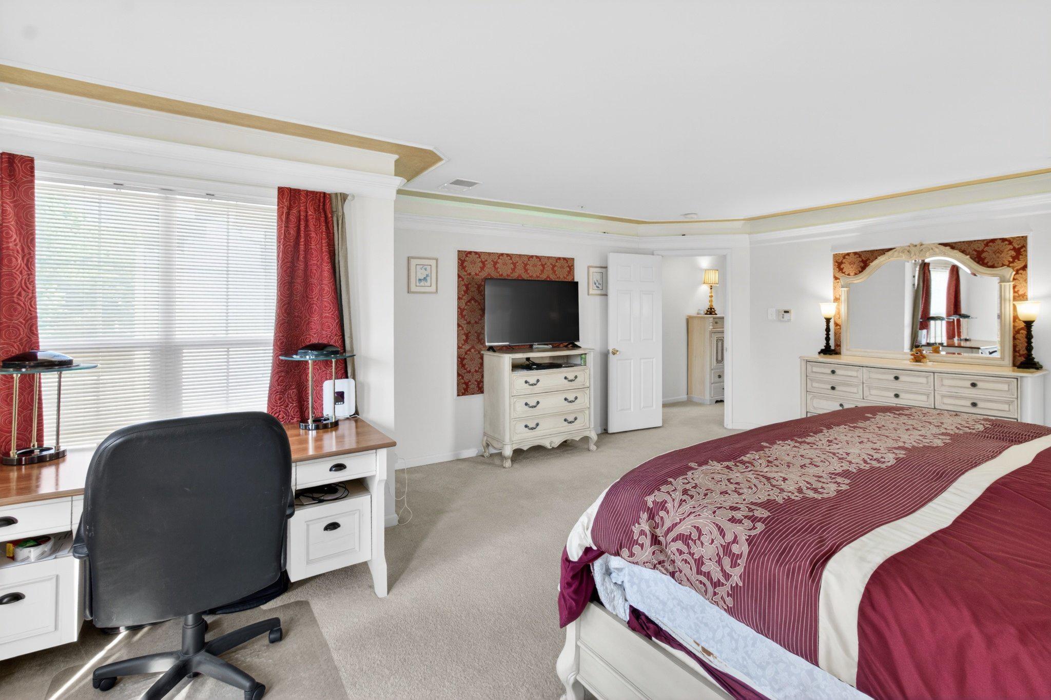 14305 Lightfoot Street Accokeek, MD 20607 - Photo 35 of 66 a bedroom with a bed and a flat screen tv