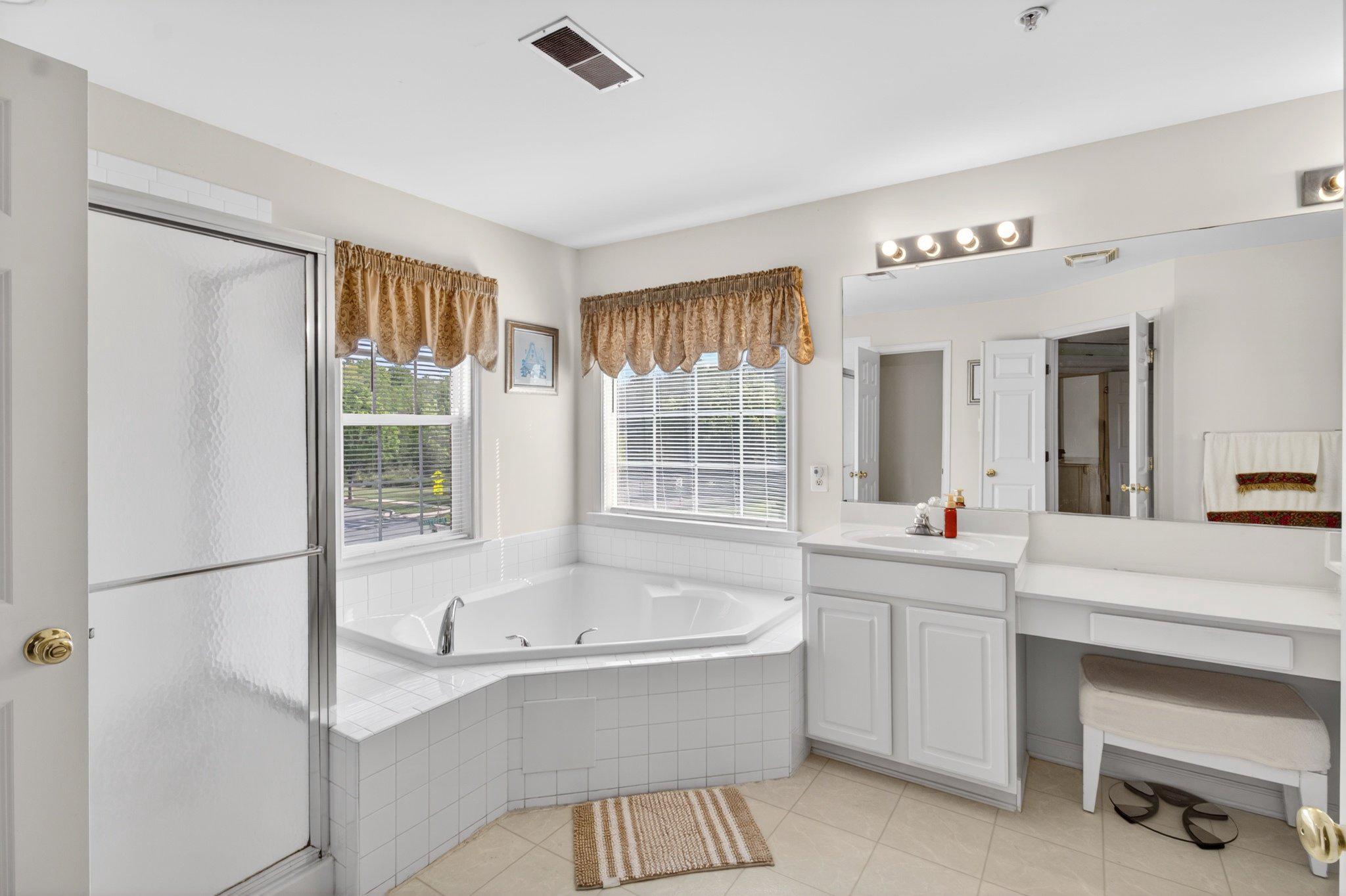 14305 Lightfoot Street Accokeek, MD 20607 - Photo 37 of 66 a bathroom with a bathtub and a sink