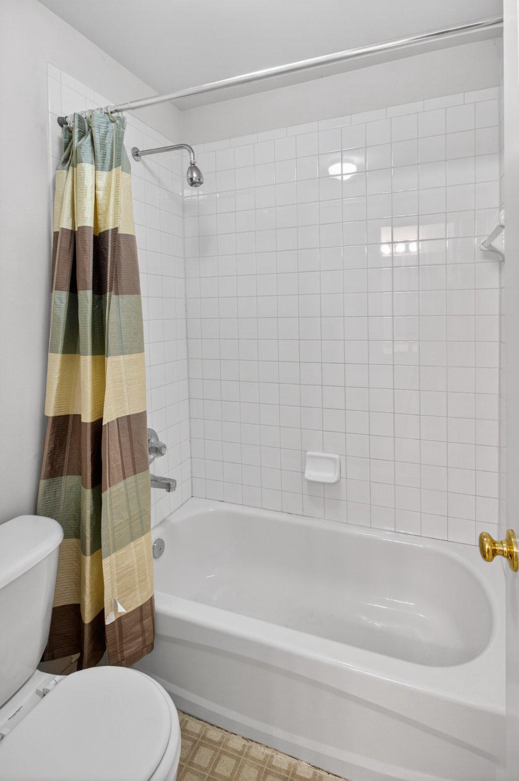 14305 Lightfoot Street Accokeek, MD 20607 - Photo 49 of 66 a bathroom with a bathtub and a shower