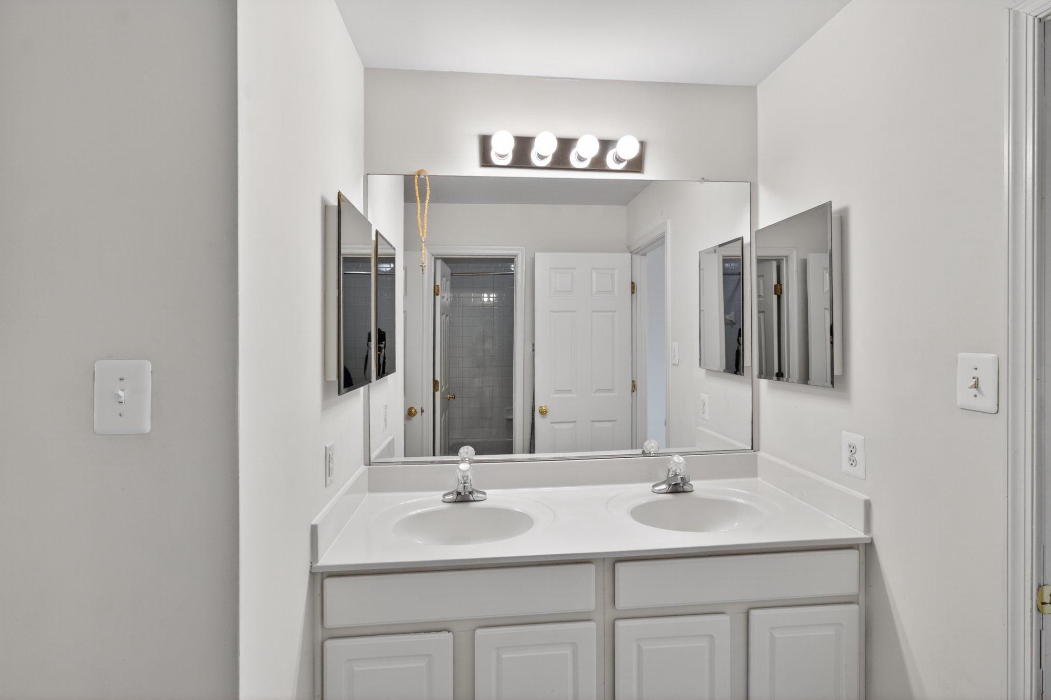 14305 Lightfoot Street Accokeek, MD 20607 - Photo 50 of 66 a bathroom with double sink and a mirror
