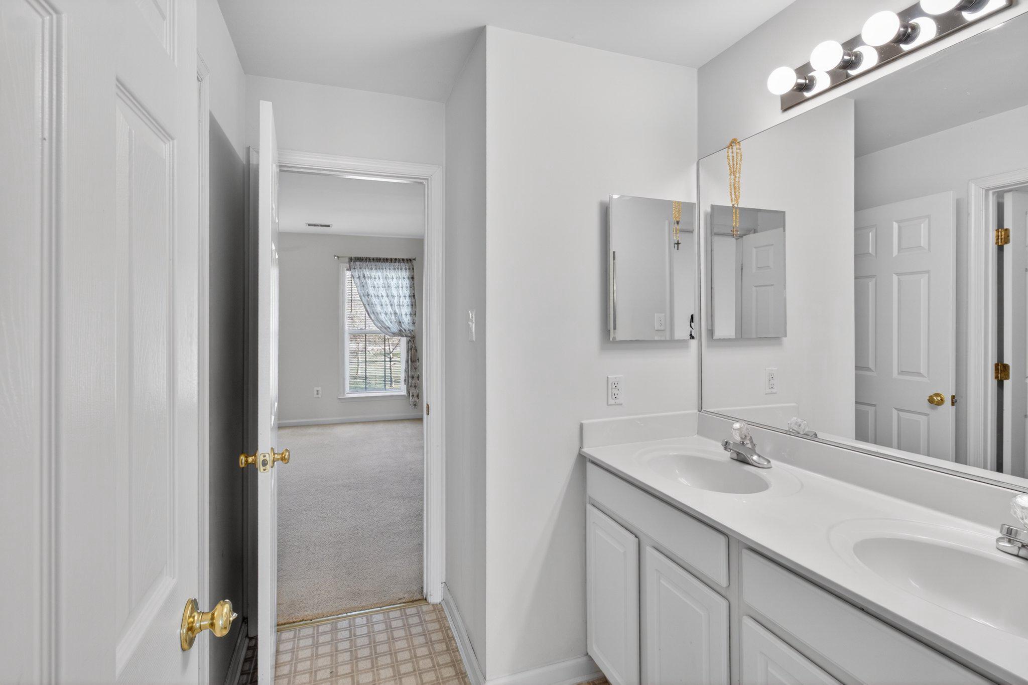 14305 Lightfoot Street Accokeek, MD 20607 - Photo 51 of 66 a bathroom with a sink double vanity and a mirror