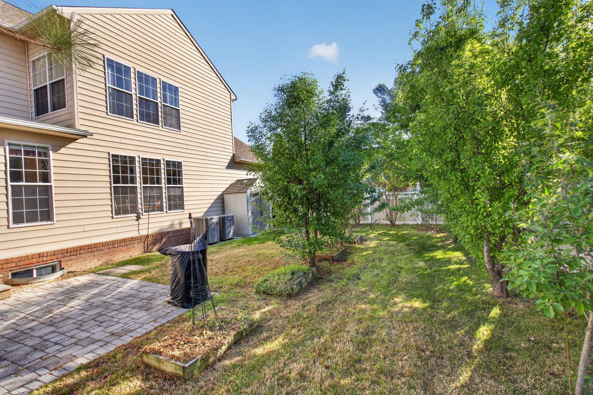 14305 Lightfoot Street Accokeek, MD 20607 - Photo 60 of 66 a front view of a house with garden