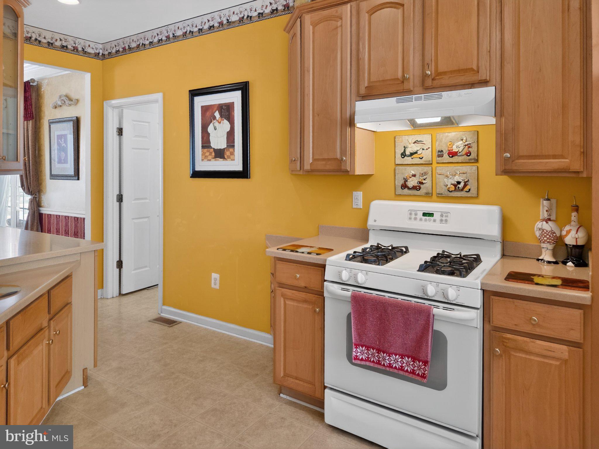14305 Lightfoot Street Accokeek, MD 20607 - Photo 7 of 11 Sunny kitchen with warm yellow walls.