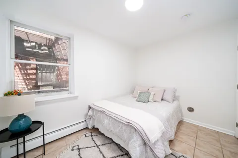 a bedroom with a bed and a painting on the wall