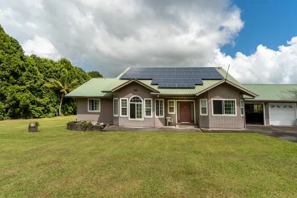a front view of house with yard and green space