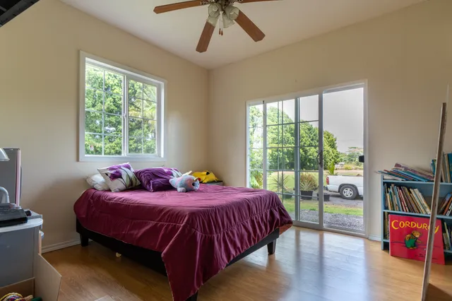 a bedroom with a bed and a large window