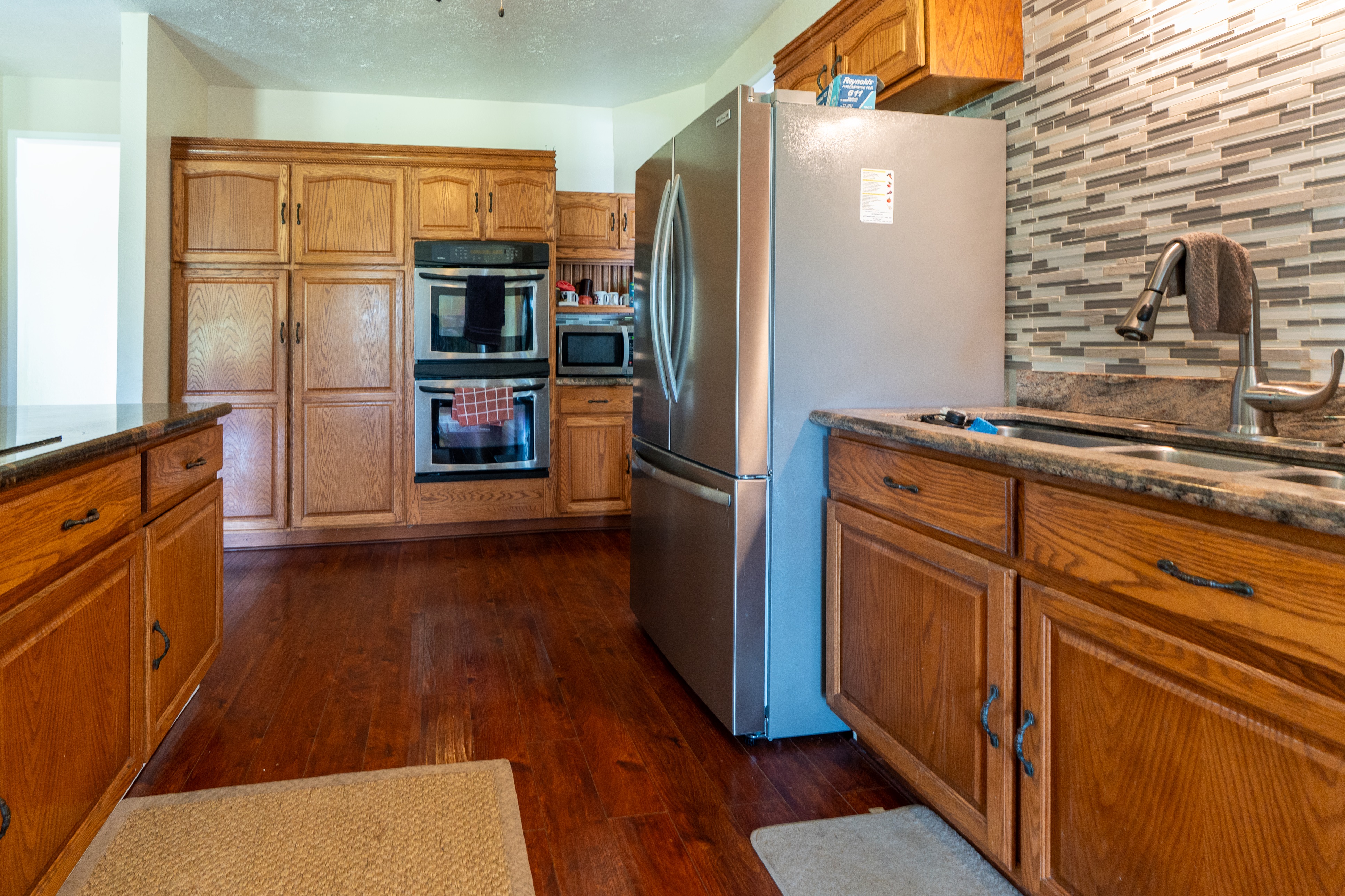 17-4044 South Road Keaau, HI 96749 - Photo 24 of 28 a kitchen with granite countertop stainless steel appliances a refrigerator and counter top