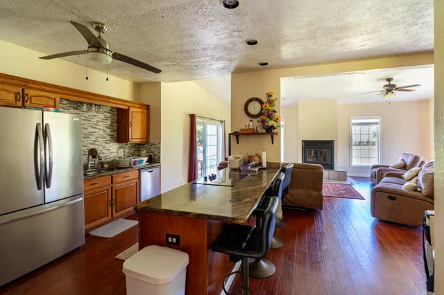 a view of a dining room with furniture a chandelier and wooden floor