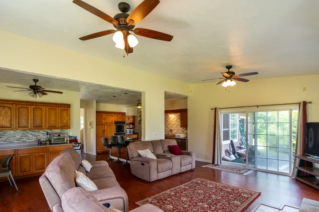 a living room with furniture ceiling fan and a rug