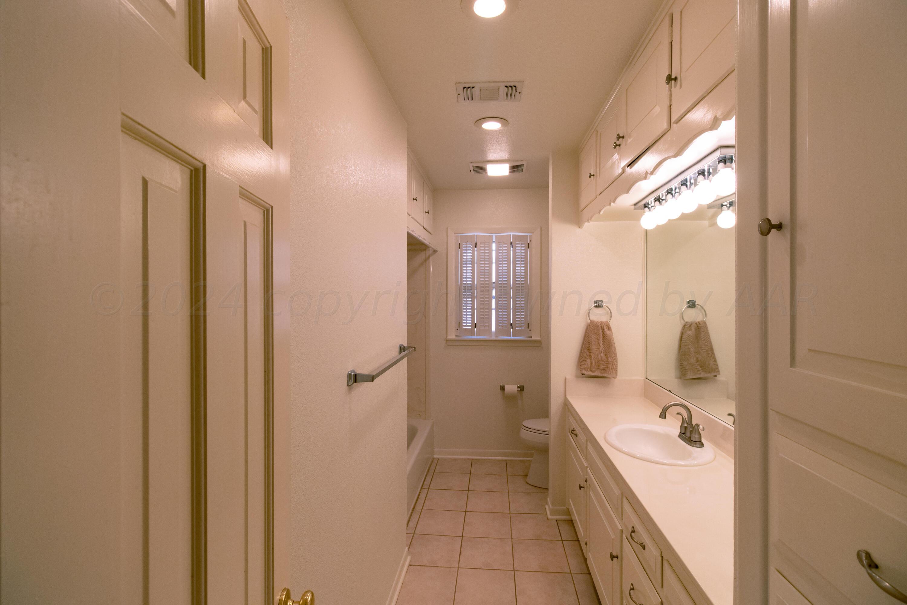 6114 Gainsborough Road Amarillo, TX 79106 - Photo 12 of 20 a bathroom with a bathtub and a shower