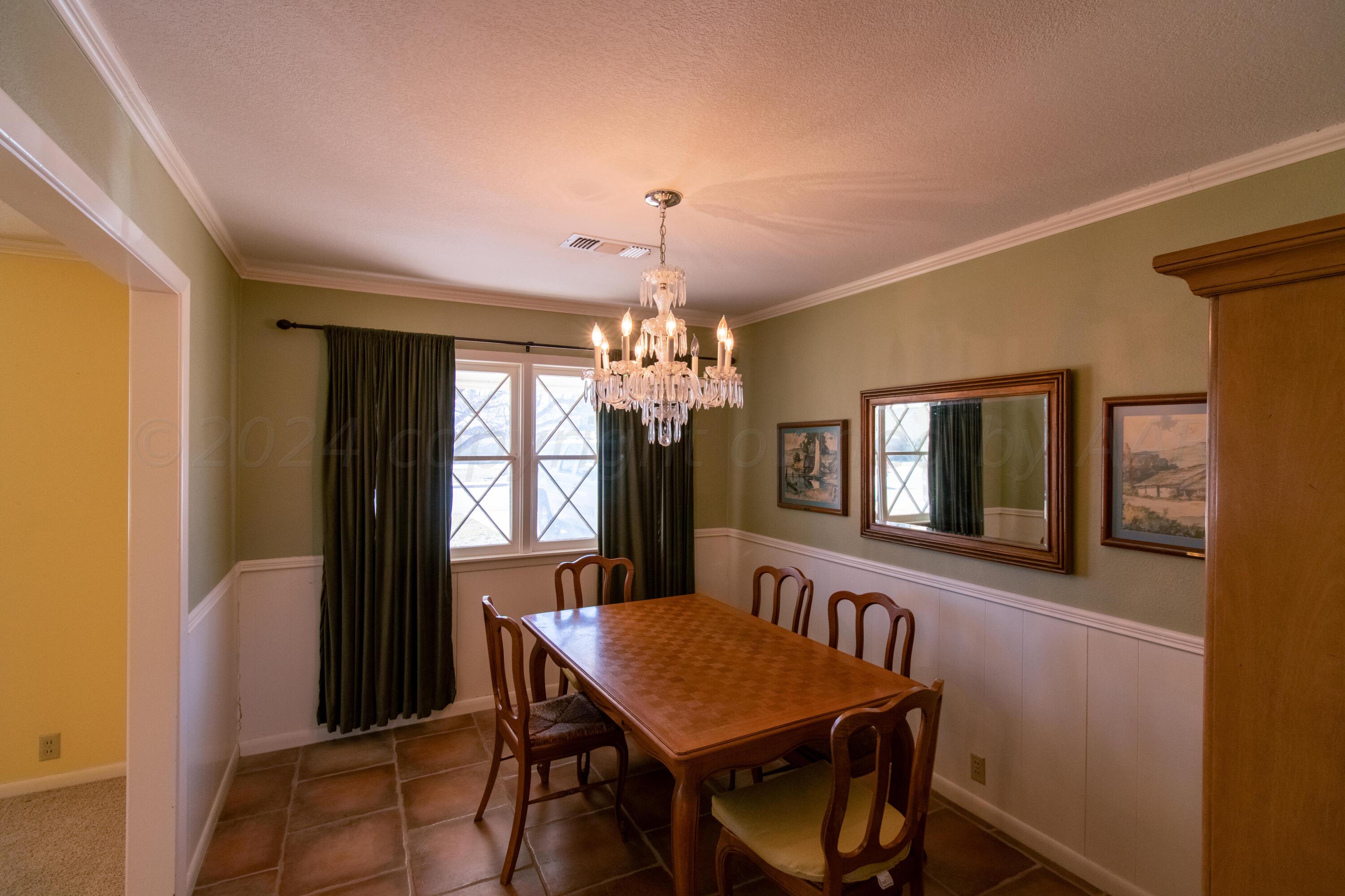 6114 Gainsborough Road Amarillo, TX 79106 - Photo 15 of 20 a view of a dining room with furniture and window