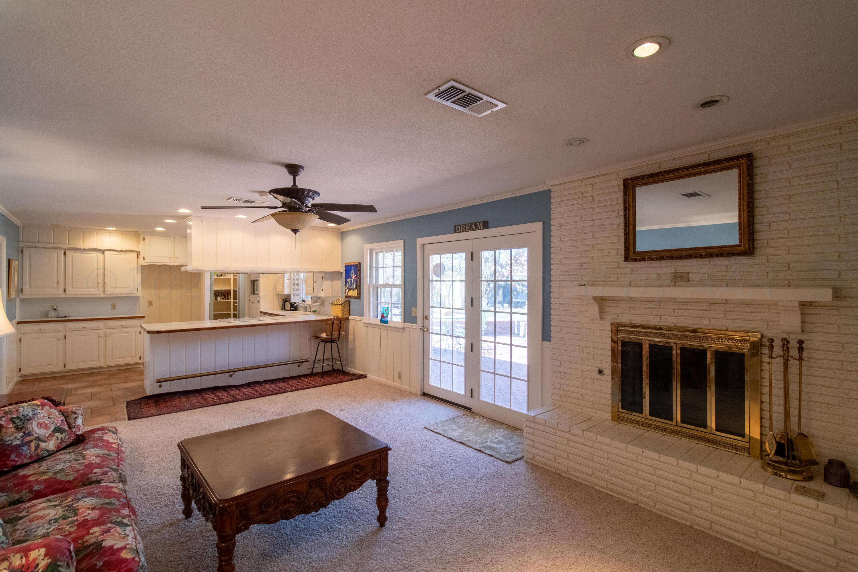 6114 Gainsborough Road Amarillo, TX 79106 - Photo 3 of 20 a living room with furniture and a fireplace