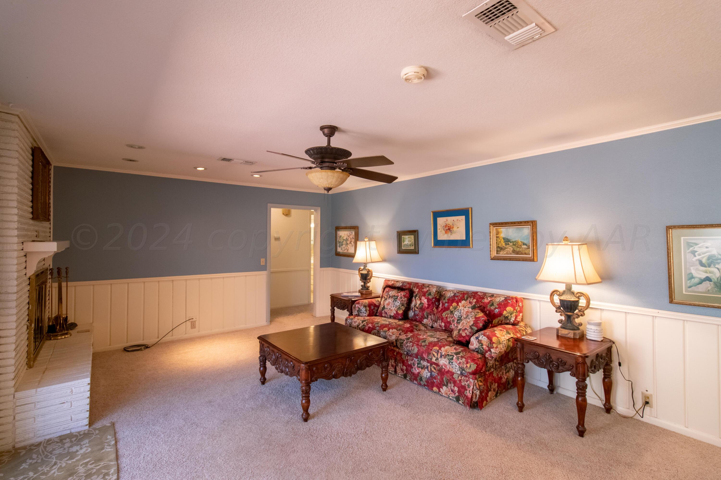 6114 Gainsborough Road Amarillo, TX 79106 - Photo 4 of 20 a living room with furniture and a chandelier