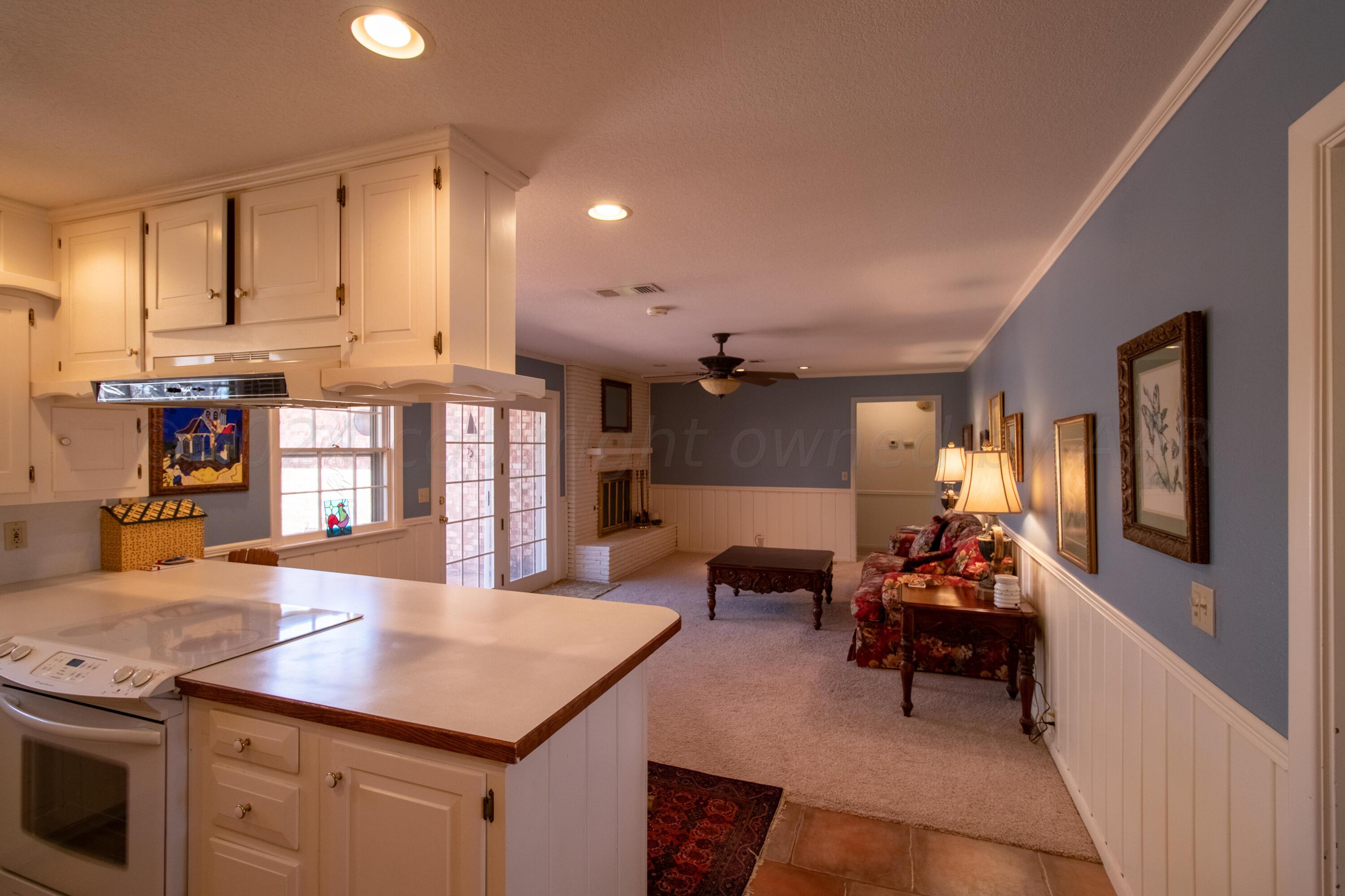 6114 Gainsborough Road Amarillo, TX 79106 - Photo 5 of 20 a kitchen with stainless steel appliances granite countertop a stove and a refrigerator