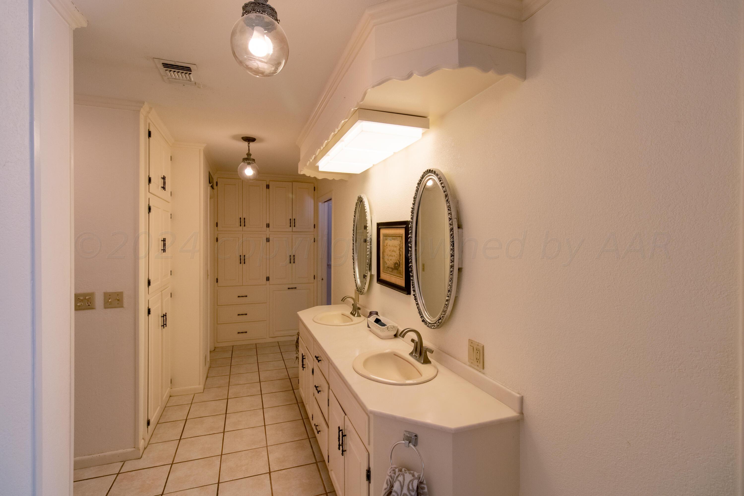 6114 Gainsborough Road Amarillo, TX 79106 - Photo 6 of 20 a bathroom with a sink a toilet and shower