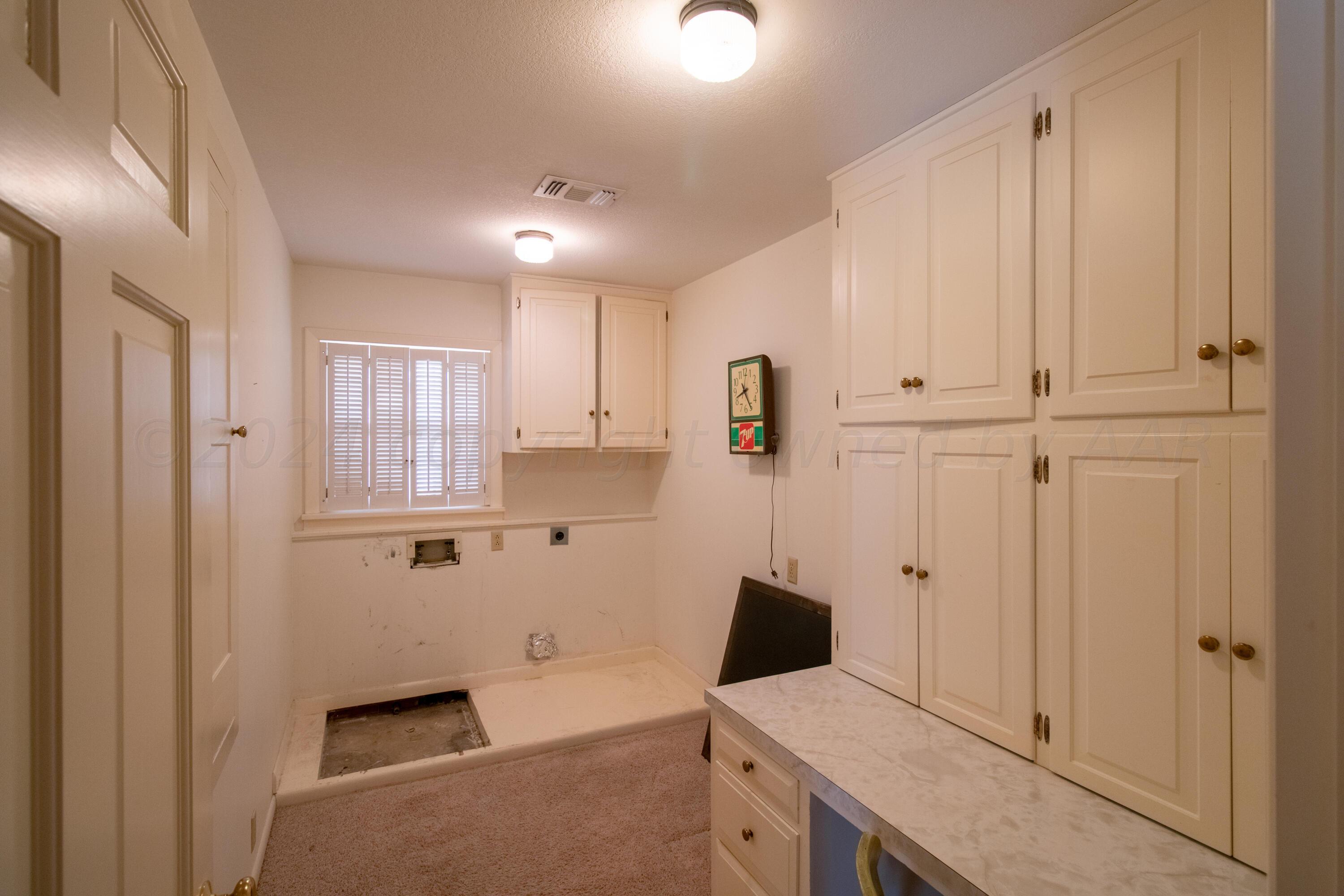 6114 Gainsborough Road Amarillo, TX 79106 - Photo 8 of 20 a view of a kitchen with white cabinets