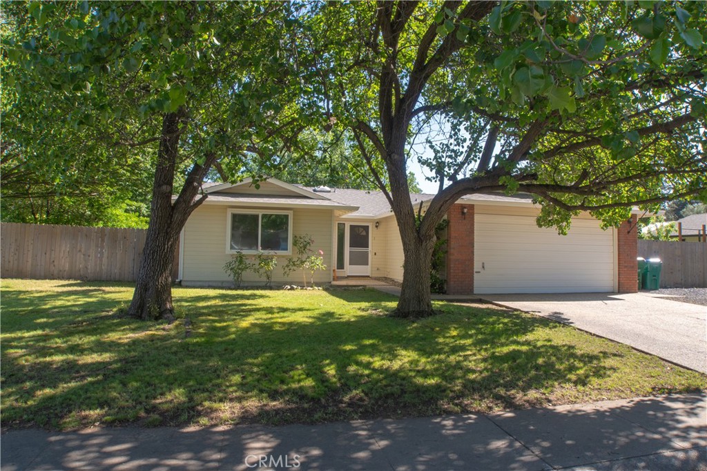 1 San Ramon Drive Chico, CA 95973 - Photo 1 of 42 a backyard of a house with yard and outdoor seating