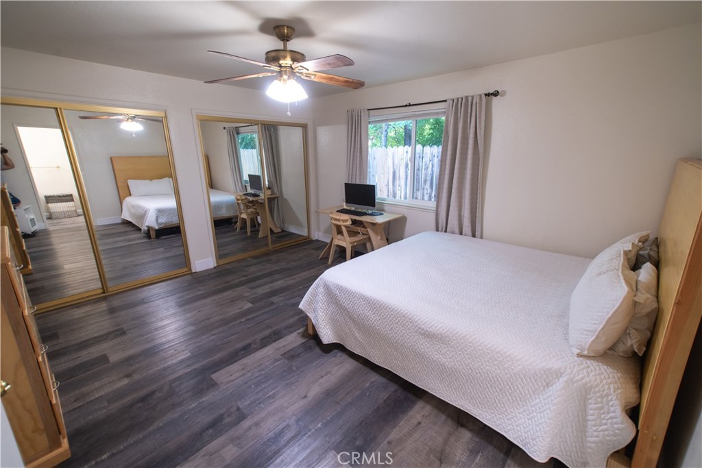 1 San Ramon Drive Chico, CA 95973 - Photo 26 of 42 a spacious bedroom with a bed and a chandelier